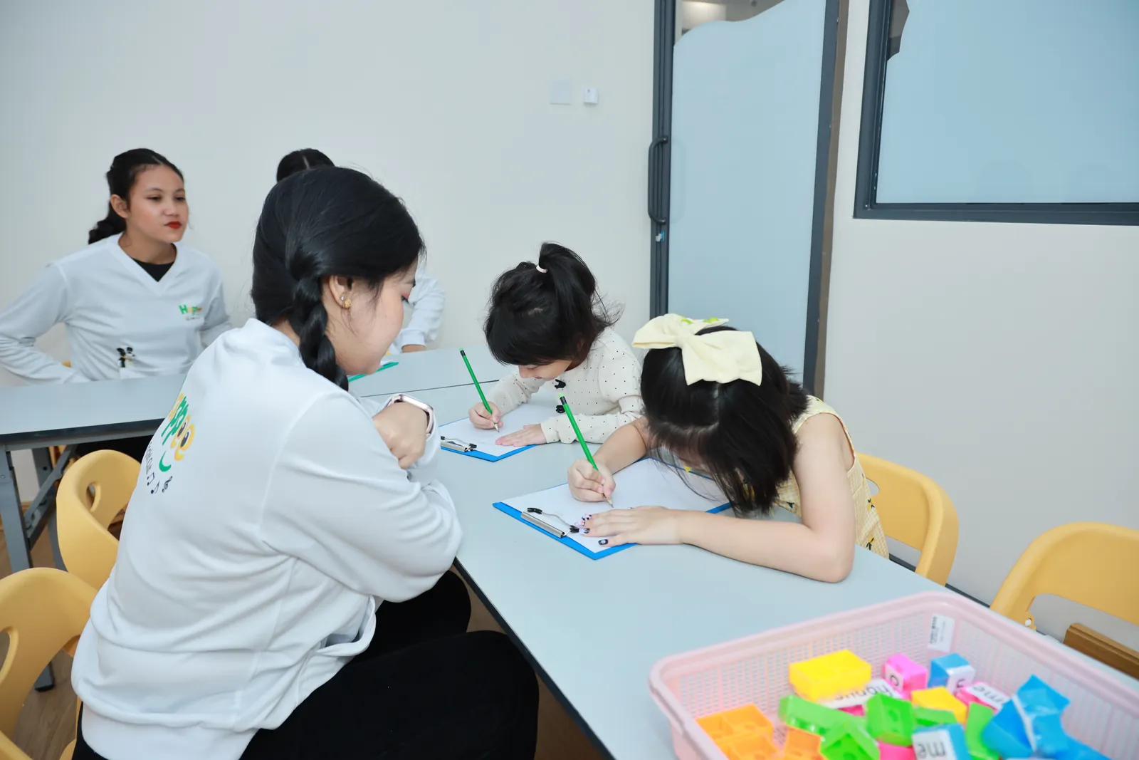Children and teachers at a classroom activity table
